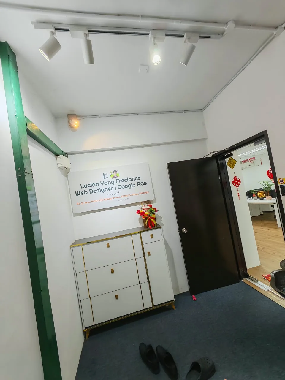 The 2nd floor landing with the same signboard beside the office door